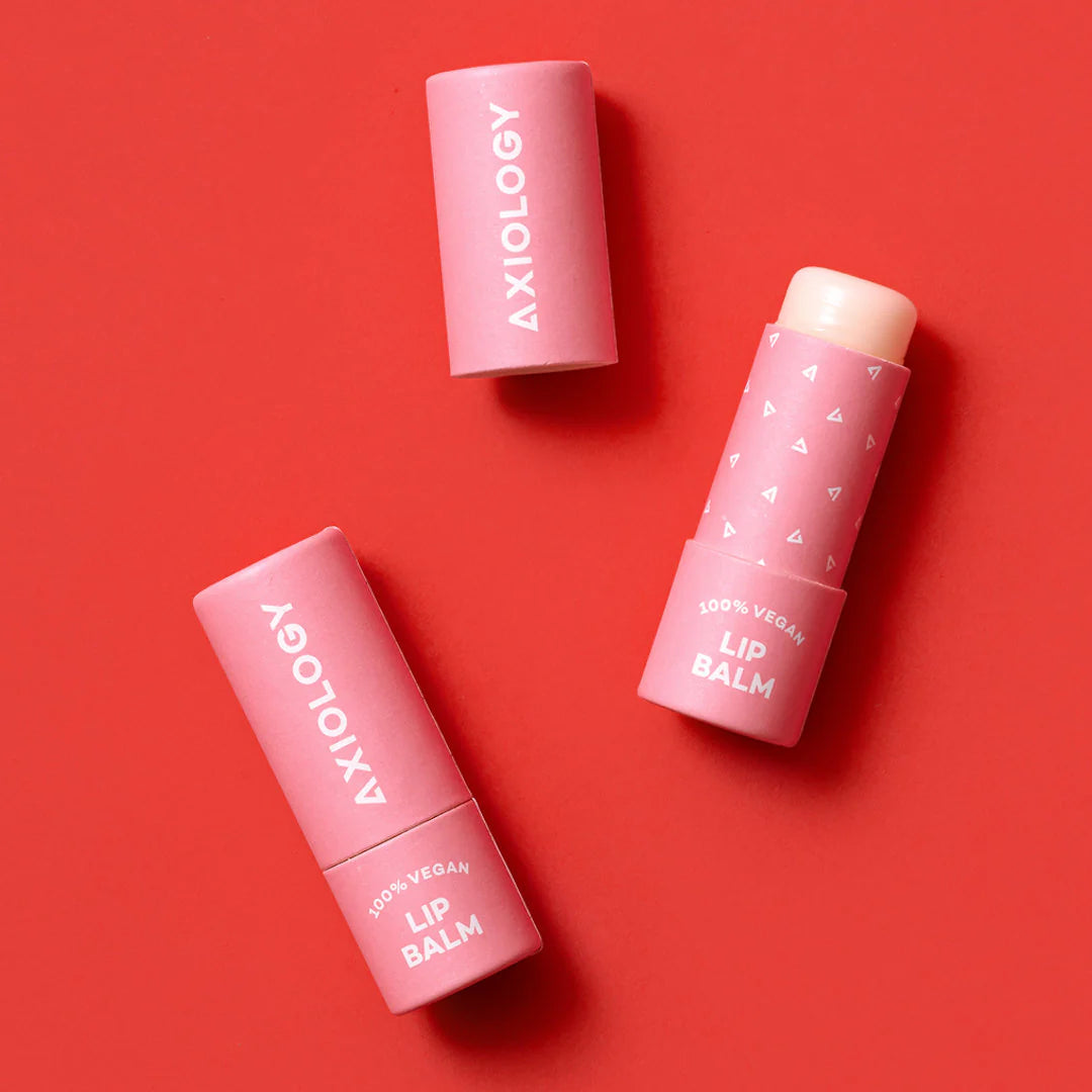 Axiology Lip Balms on a Red background